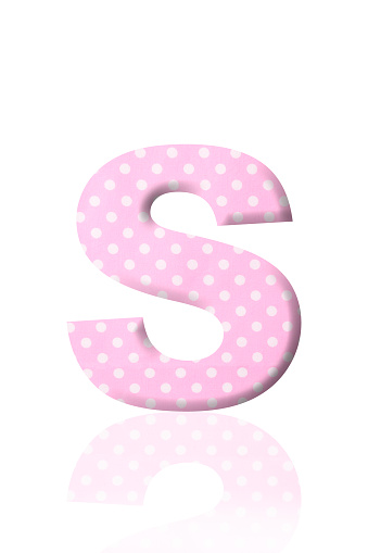 Close-up of three-dimensional polka dot alphabet letter S on white background.