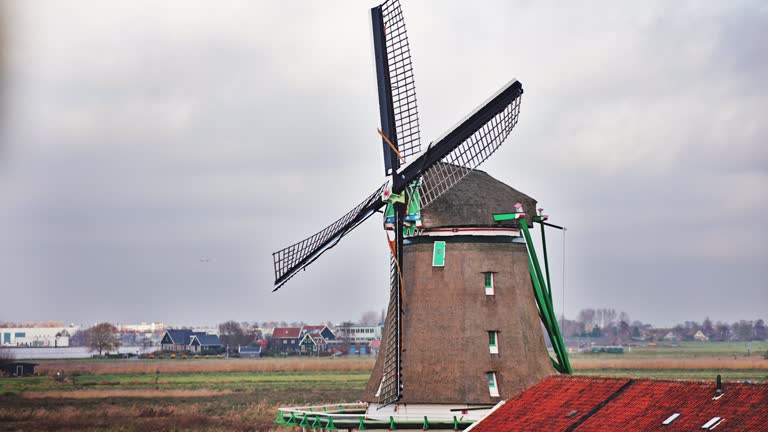 Traditional windmills in Zaanse Schans in the Netherlands, Spinning mills, Rural landscape with windmills in the Netherlands, Ancient wooden windmills in Zaanse Schans, the most popular tourist attraction in the Netherlands