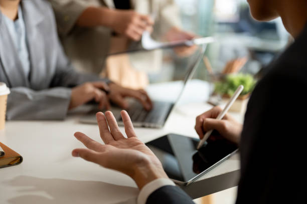 istock A businessman is taking notes on his tablet while having a meeting with his team in the office. 1953780693