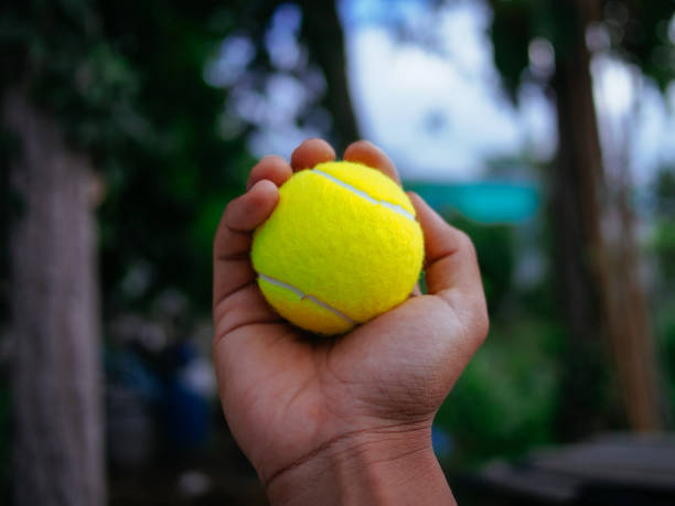 istock holding tennis ball 1953783300