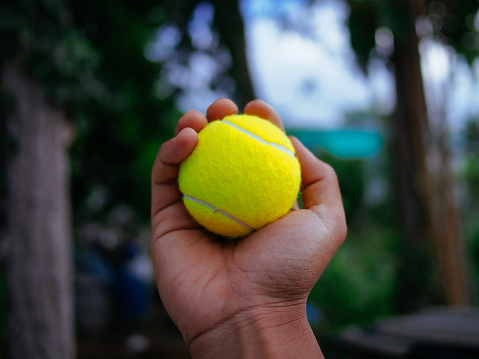 holding tennis ball