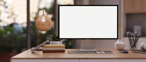 istock A modern office with a PC computer mockup, stationery, and a modern table lamp on a wooden desk. 1953783310