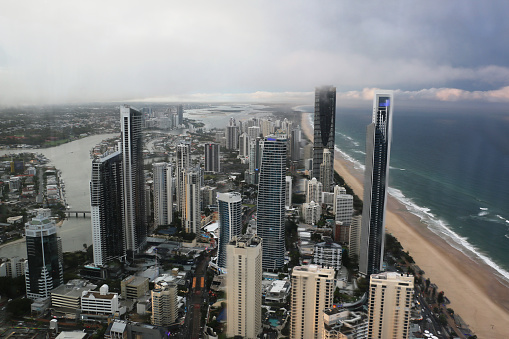 North view from Surfers Paradise / Broadbeach, all the way to Spit, Sundale Bridge, Broadwater, and far horizon. Taken following afternoon storm, overcast with cloud cover. Looking through window into low light, giving some refractions and blur.