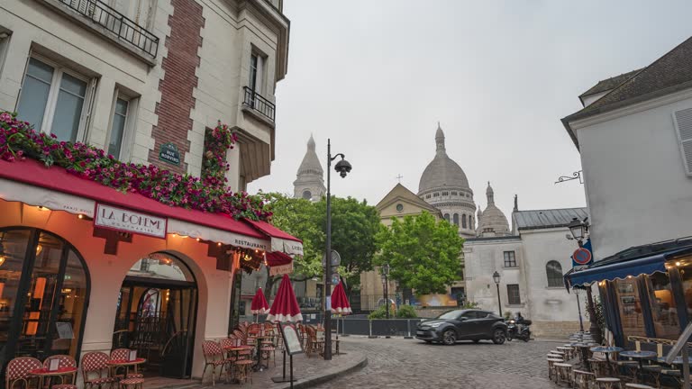 Paris France, city skyline time lapse of architecture building on Montmartre street and Sacre Coeur