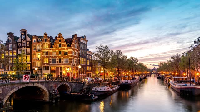 Amsterdam Netherlands time lapse 4K, city skyline day to night timelapse at canal waterfront
