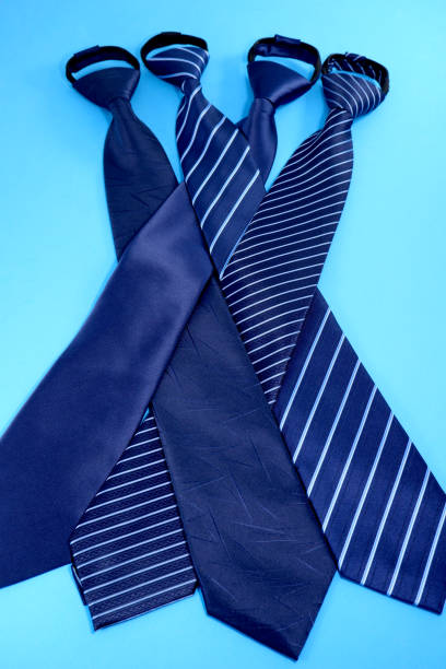 istock Group neckties layered together  with blue background close-up view 1953866659