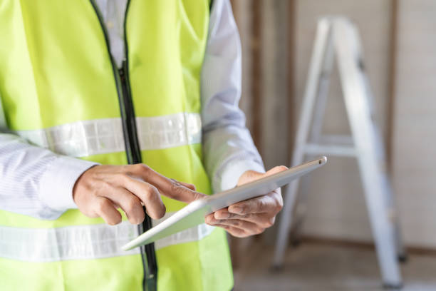 istock inspector or engineer is inspecting construction and quality assurance new house using a tablet. Engineers or architects or contactor work to build the house before handing it over to the homeowner 1953875021