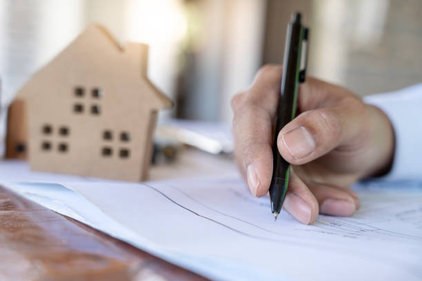 istock Engineers use blueprint check construction on site. Contractor and inspector inspection construction during project.civil Forman check quality assurance. Audit, inspect, quality control. 1953875528