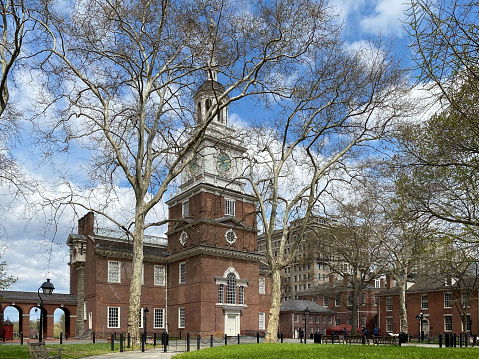 This is the south-facing side of Independence Hall in Philadelphia. It is a popular tourist destination in America because the Declaration of Independence was signed here in 1776. Photo is taken at Independence Square, which is a public park behind the building.