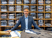 Happy retail clerk working at a men's clothing store