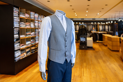 Interior of a high-quality clothing shop for men with many suits and neckties on display