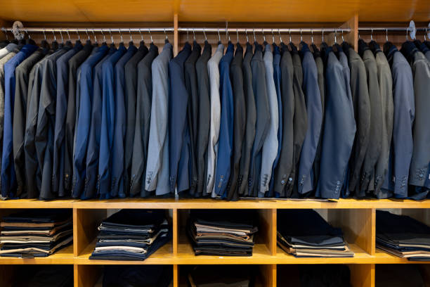 Business jackets hanging on a rack at a clothing store -  fashion concepts