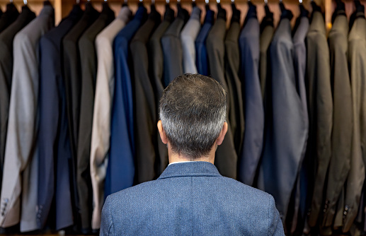 Rear view of a Latin American man shopping at a clothing store - menswear concepts