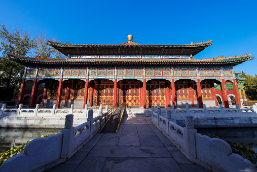 Historical buildings in Beihai Park, Beijing, China. It is a traditional Chinese royal Buddhist building. It is surrounded by archways and the main hall in the middle.