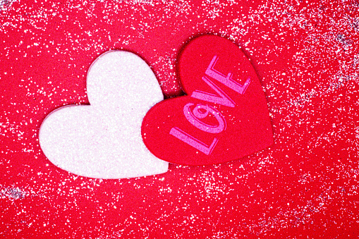 Glittery assortment of hearts on red and white background for Valentines Day