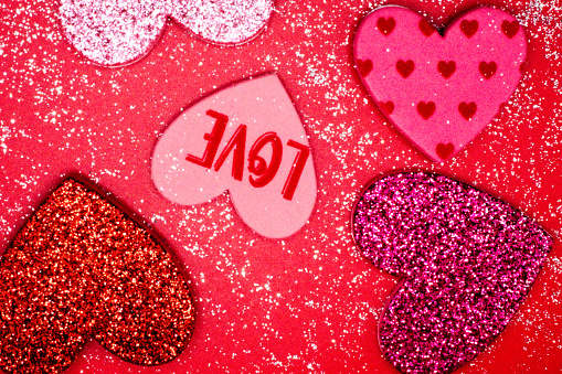 Glittery assortment of hearts on red and white background for Valentines Day