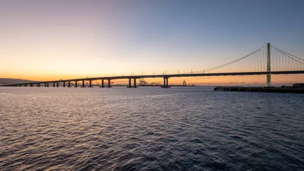 Aerial photo of early morning sunrise looking towards the San Francisco Bay Bridge and Oakland, CA.