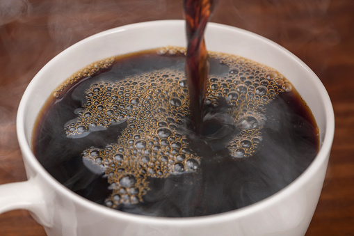 Pouring Freshly Brewed Coffee into a Cup