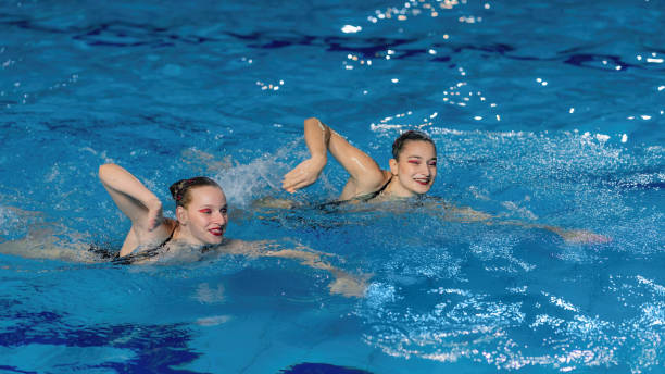 istock An elegance as the synchronized swimming duo performs their enchanting routine in the shimmering pool waters. 1954134118