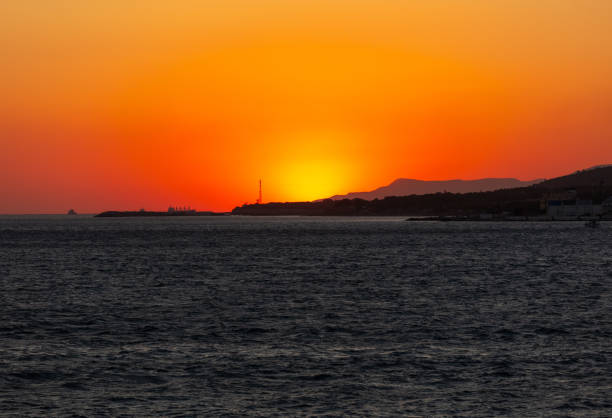 istock Hiding behind an island at sea. Sunset 1954136200
