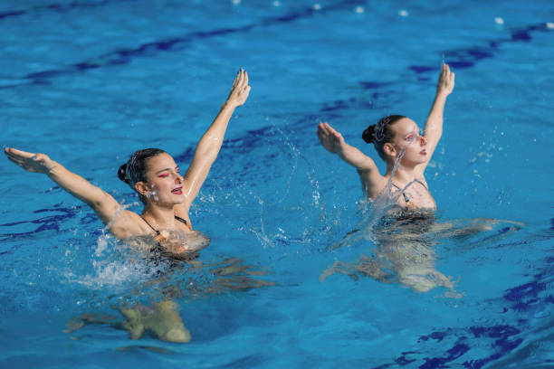 istock Synchronized swimming duo gracefully dances through the water, showcasing seamless coordination and enchanting aquatic choreography 1954136208