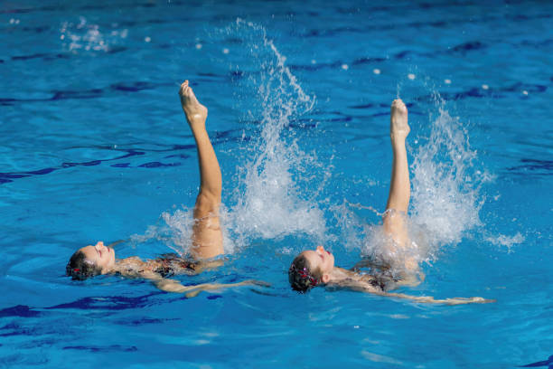 istock Synchronized swimming duo gracefully dances through the water enchanting aquatic choreography 1954136719