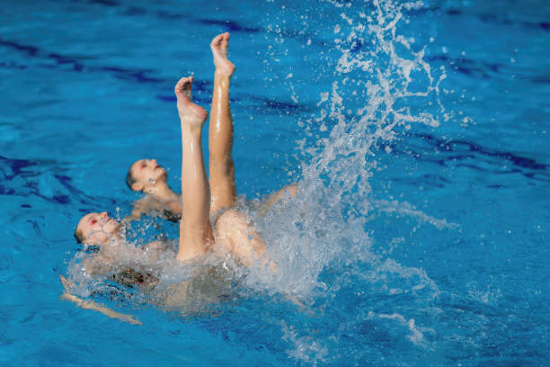 istock Synchronized swimming as this duet mesmerizes with fluid movements and elegant choreography in the pool 1954137250
