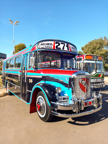Avellaneda, Argentina - May 7, 2023: Old blue 1974 Mercedes Benz 911 bus for public passenger transport in Buenos Aires at a classic car show. Traditional fileteado ornaments. Copy space
