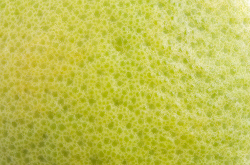 The surface texture of the Yellow pomelo fruit, grapefruit or Citrus maxima, macro close up.