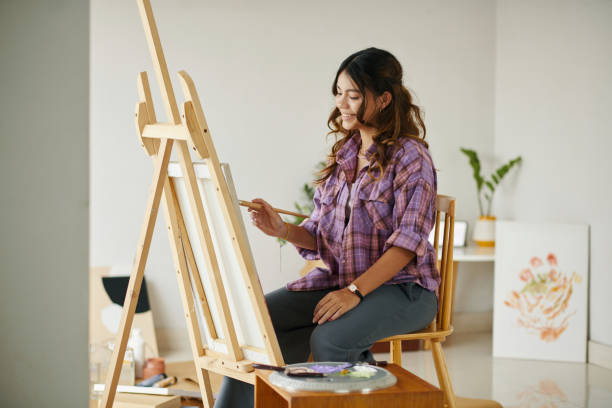 istock Girl Enjoying Painting on Easel 1954175247