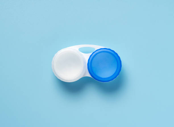 Case of contact lenses placed on a blue background. View from above.