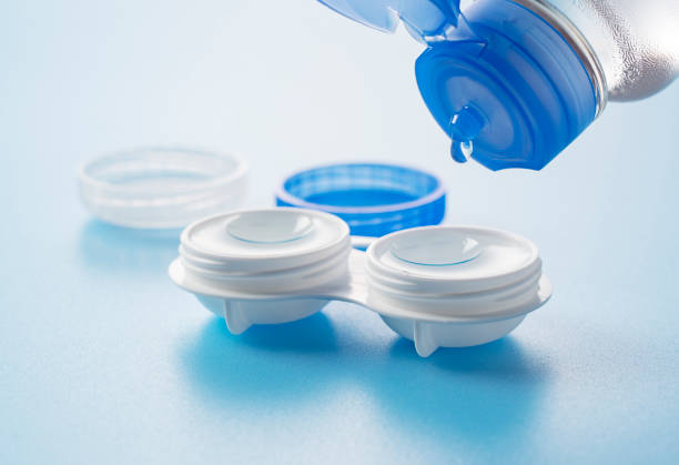 istock Case of contact lenses placed on a blue background. Pouring the protective solution. 1954180554