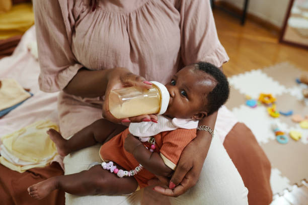 istock Mother Feeding Baby Girl 1954197342