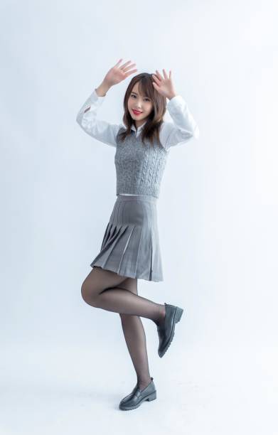 istock Asian school girl with hands up 1954198436