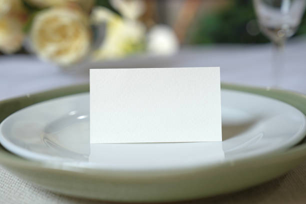 istock Mockup white blank space card, for Name place, Folded, greeting, invitation on wedding table setting background. 1954198949