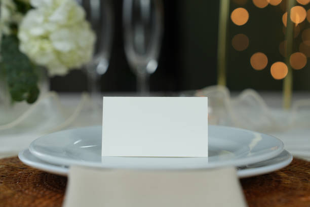 istock Mockup white blank space card, for Name place, Folded, greeting, invitation on wedding table setting background. 1954198999