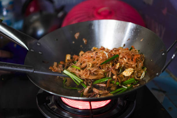 istock Image of a cook making Pad Thai with fresh shrimp in a hot pan for a packed lunch. 1954208675