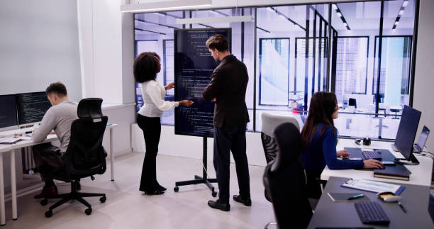 istock Programmer Team Meeting With TV Screen In Office 1954209023