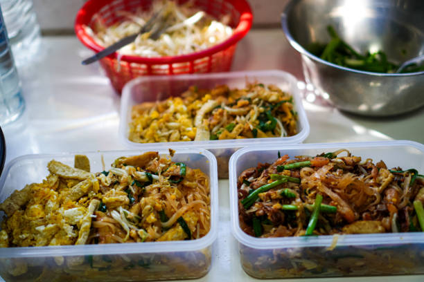 Front view of fresh shrimp pad thai menu for packed lunch on cooking table