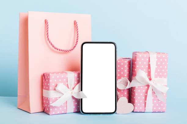 istock mobile phone with blank screen on colored background with hearts, calendar and gift box, valentine day concept perspertive view flat lay 1954219829