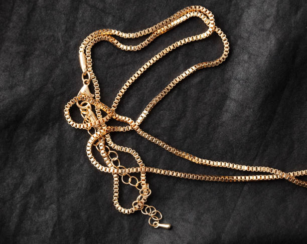 istock Gold chain on black silk fabric. Close-up 1954222562