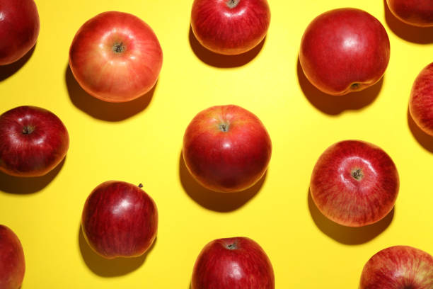 istock Ripe red apples on yellow background, flat lay 1954236928