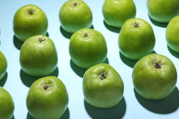istock Ripe green apples on light blue background, closeup 1954238000