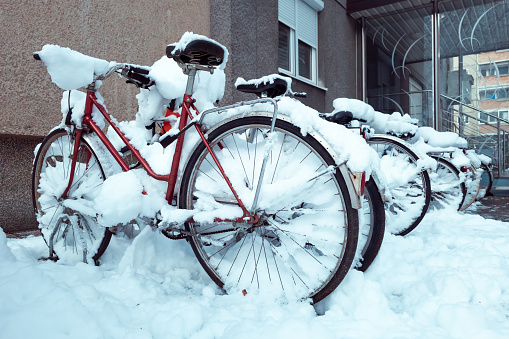 Bicycles covered with white snow