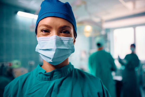 istock Happy female surgeon in operating room looking at camera. 1954249588