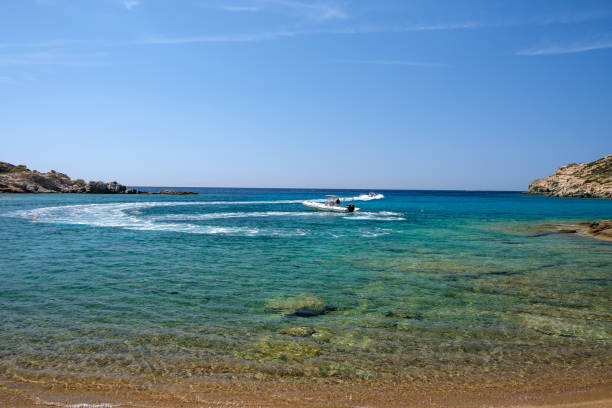 Ios, Greece - September 15, 2023 : View of two touristic excursion speed boats at the beach of Pikri Nero in Ios Greece