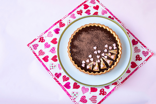 chocolate tart with paper napkin of heart pattern. Valentine sweets.