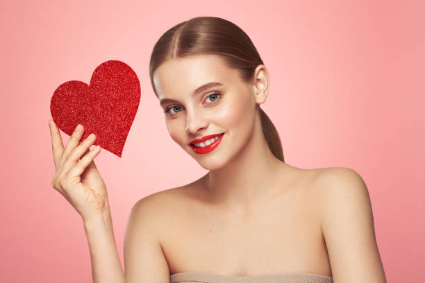 istock Beautiful woman holding an artificial red heart 1954251900