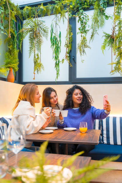 istock Friends taking selfie while drinking coffee in a cafeteria 1954252790