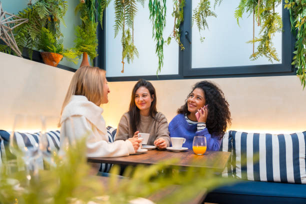 istock Woman talking distracted while drinking coffee in a cafeteria 1954252791